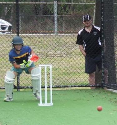 Tomas Morrissy displays his wicketkeeping style under supervision from Firsts player Dean Coxall.