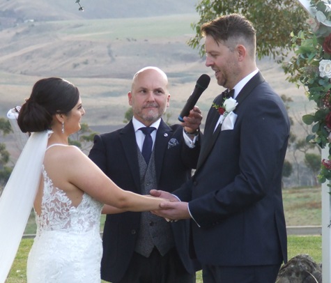 Vanessa and Matt exchange vows with the preacher.