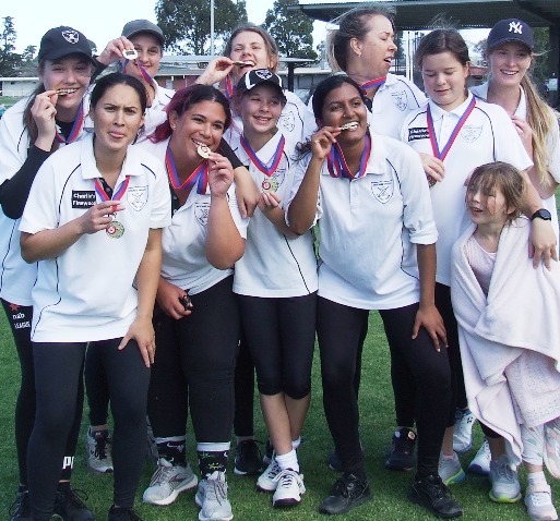 Premiers - and proud to show their medals: L-R Tara Newman, Yasmin King, Sandra Verschoor, Tanya Intagliata, Sarah Ronayne, Katherine Baker, Jane Raman, Sarah Gooden, Audrey Brown and Kelsie Armstrong, with Katherine's sister.