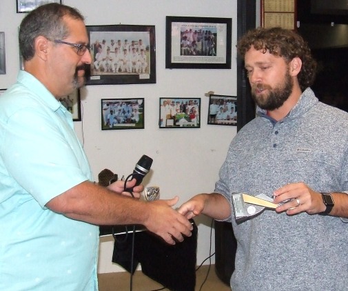 Coach/Firsts captain Brayden McGregor (far right) receives his bowling award from the night's MC, Brendan "Jonty" Rhodes.