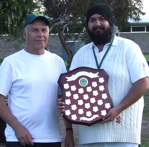 Moonee Valley captain Manu Singh (right) receives the Premiership shield from Mercantile Cricket Association secretary Rhidian Thomas.