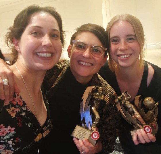 Celebrating the season and the awards: L-R captain Sarah Fenn with Kylie Russo and Fiona Bathie and their comp-wide trophies.