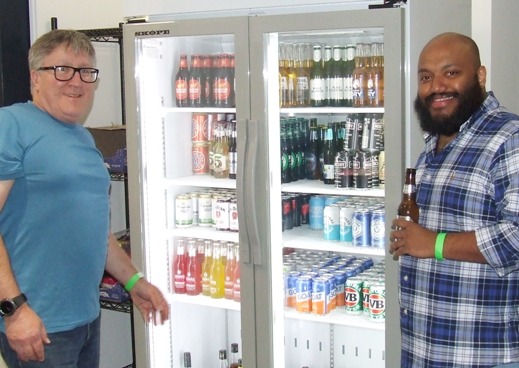 What's a function without a few refreshments? Committee members Peter Golding (Left) and Manu Poulose check on the status of the new bar fridge.