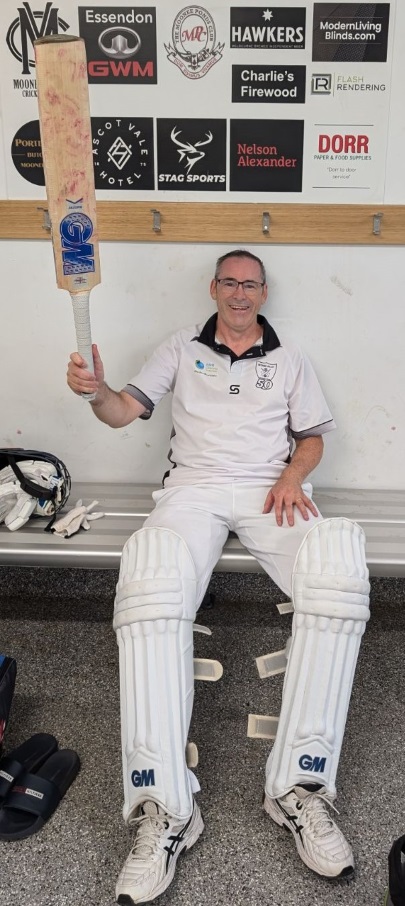 James Smith raises his bat in the Ormond Park changerooms after his unbeaten century for the Fifths.