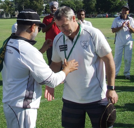 Geoff McKeown receives his medallion from captain Sunny Sharma.