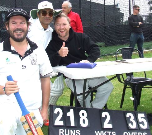Ryan Chirgwin (left) shows the score at the end of his big innings - joined by Sudarshan Devkota (middle) and Sam Kater.